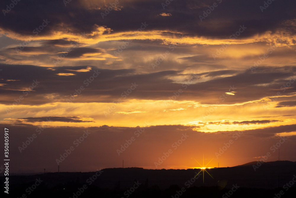 Beautiful sunset or sunrise with clouds and sun on the horizon