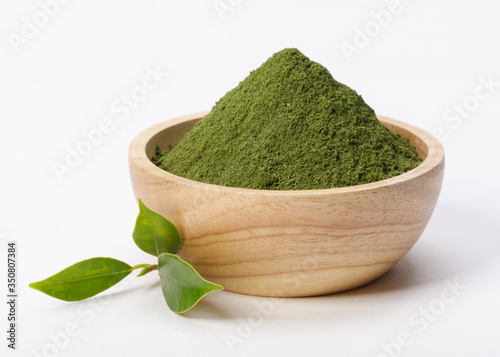 Matcha green tea powder in bowl with Organic green tea leaf isolated on white background, Organic product from the nature for healthy with traditional style