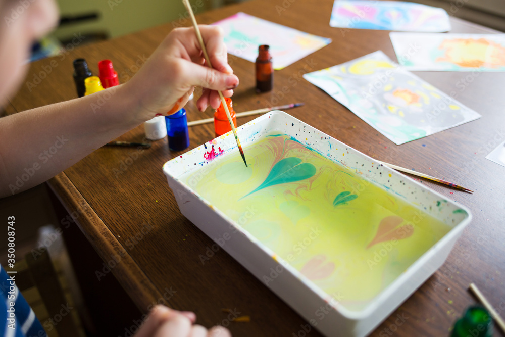 children draw paint on water at home. craft ebru. creative art for kids. Valentine's day or mother's day greeting card children draw paint on water at home. craft ebru. creative art for kids. Valentine's day or mother's day greeting card
