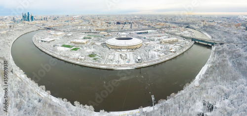 Aerial view of stadium and Moskva river. Moscow-city towers on the horizon. Beautiful spring sunrise over the city