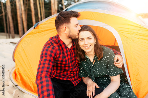 Couple in love spend time in a camp in the forest