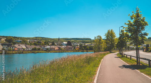 Moselle river promenade in Luxembourg with the German town of Nittle on the other side