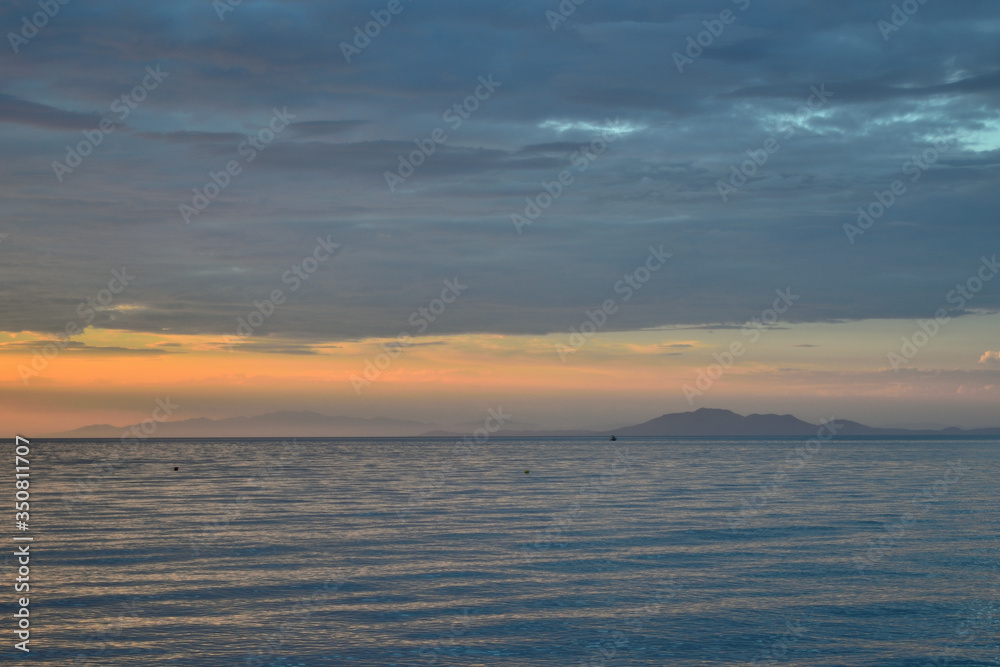 Cloudy sunset over the sea at Therma beach - Thassos at horizon – Samothraki island, Greece, Aegean sea