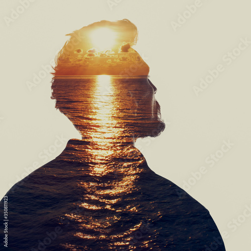Double exposure portrait of a man in contemplation at sunset time