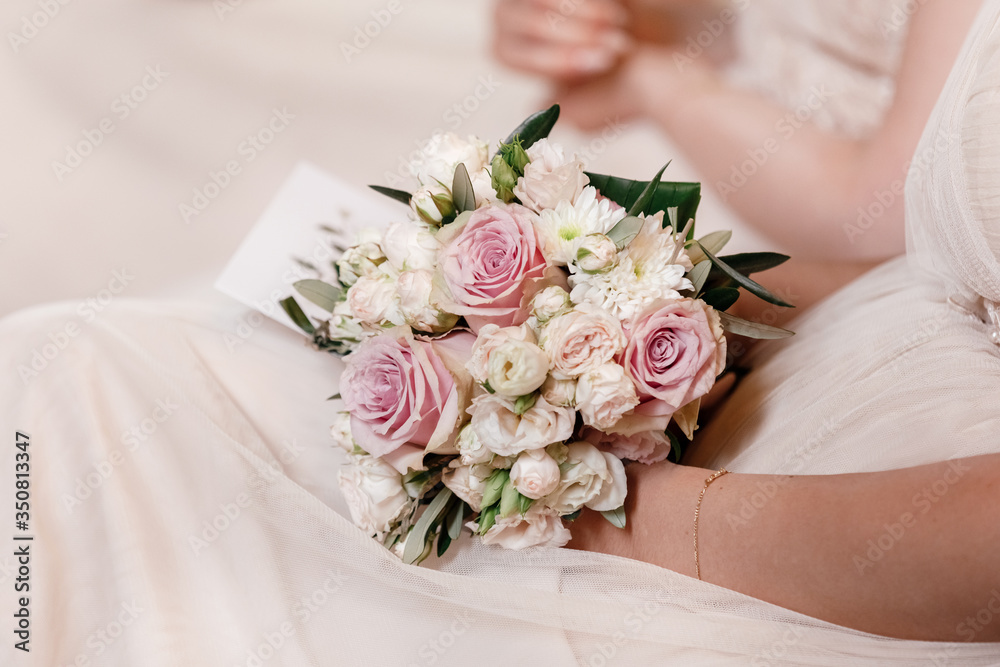 bride is holding a wedding colorful bouquet. Beauty of colored flowers. Close-up bunch of florets. Bridal accessories. Female decoration for girl. Details for marriage and for married couple bride is holding a wedding colorful bouquet. Beauty of colored flowers. Close-up bunch of florets. Bridal accessories. Female decoration for girl. Details for marriage and for married couple