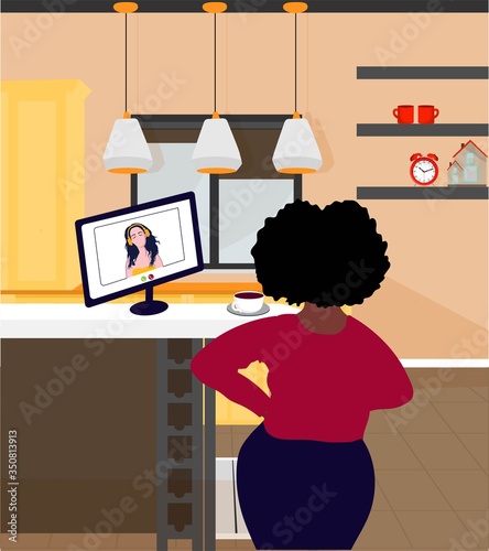 A black woman in the kitchen is working and preparing food. Home office interior. The concept of remote work. Freelance. Audio books and online conferencing