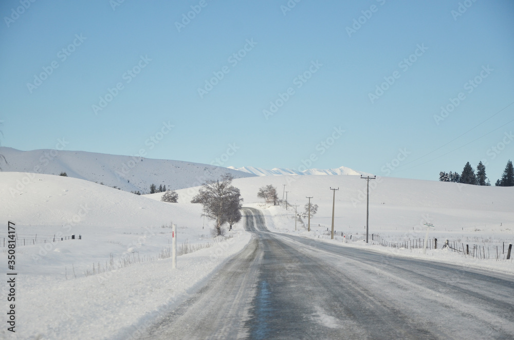 The winter snowy road from Lake Tekapo to Christchurch. The journey pass through several towns and along farmland, then the scenery will start to become mountainous. The winter snowy road from Lake Tekapo to Christchurch. The journey pass through several towns and along farmland, then the scenery will start to become mountainous.