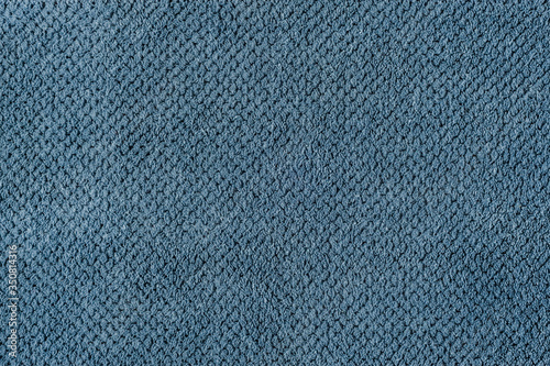 The texture of the fabric is plush blue. Abstract texture.