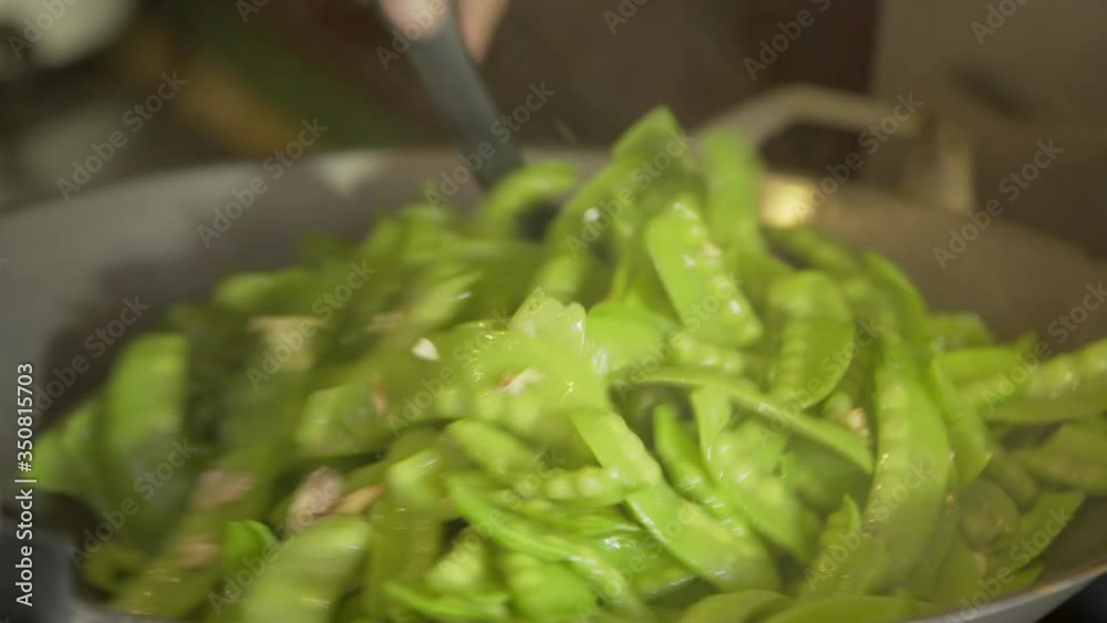 Close-up of person preparing fresh green peas in cooking utensil - Chiang Rai, Thailand Close-up of person preparing fresh green peas in cooking utensil - Chiang Rai, Thailand