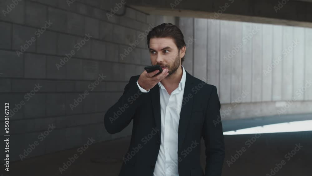 Business man talking on phone loudspeaker at street. Man standing at street Business man talking on phone loudspeaker at street. Man standing at street