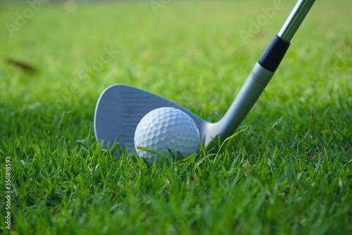 Golf balls on the golf course with golf clubs ready for golf in the first short. In the morning, with the beautiful sunlight.Sports that people around the world play in the holidays.