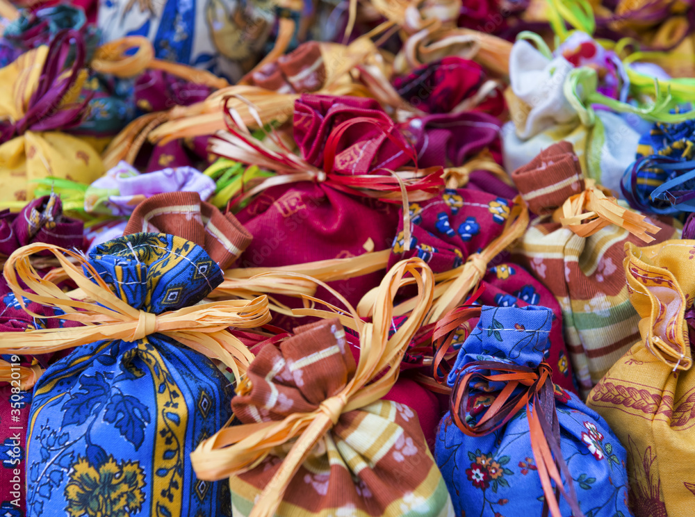 Colorful textile small bags tied with a straw string