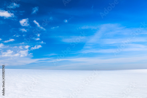 Winter landscape with bright snow and blue sky.