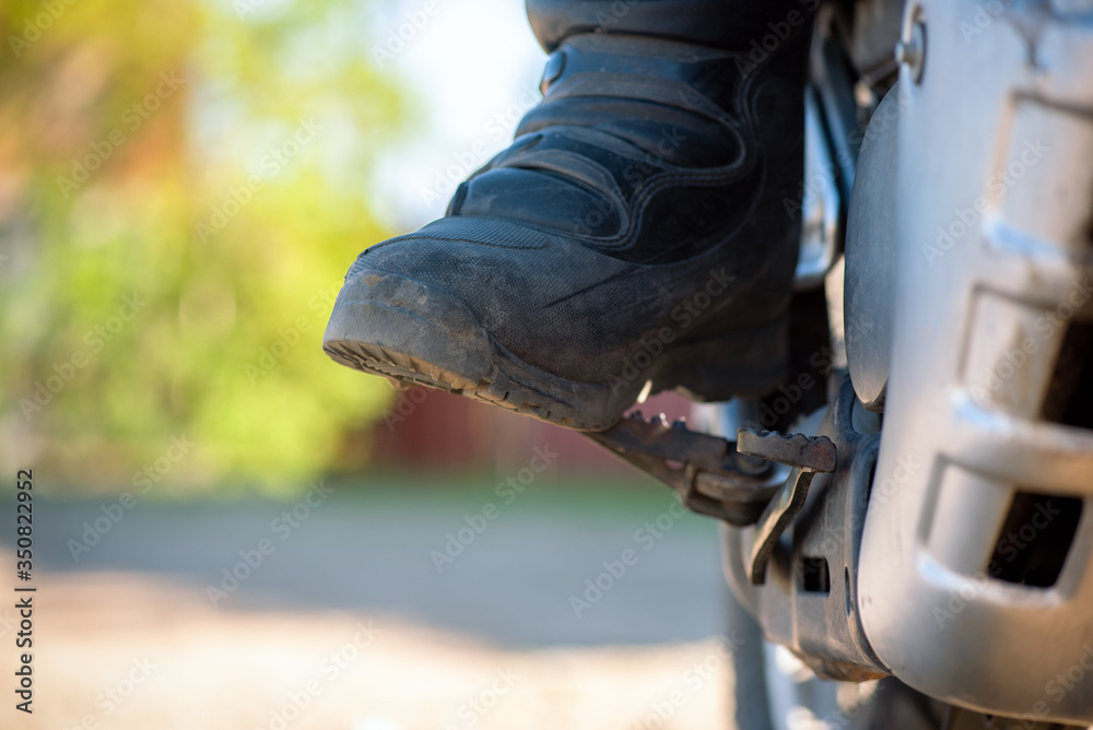 Motor biker leg in the boot close up. Motor biker leg in the boot close up.