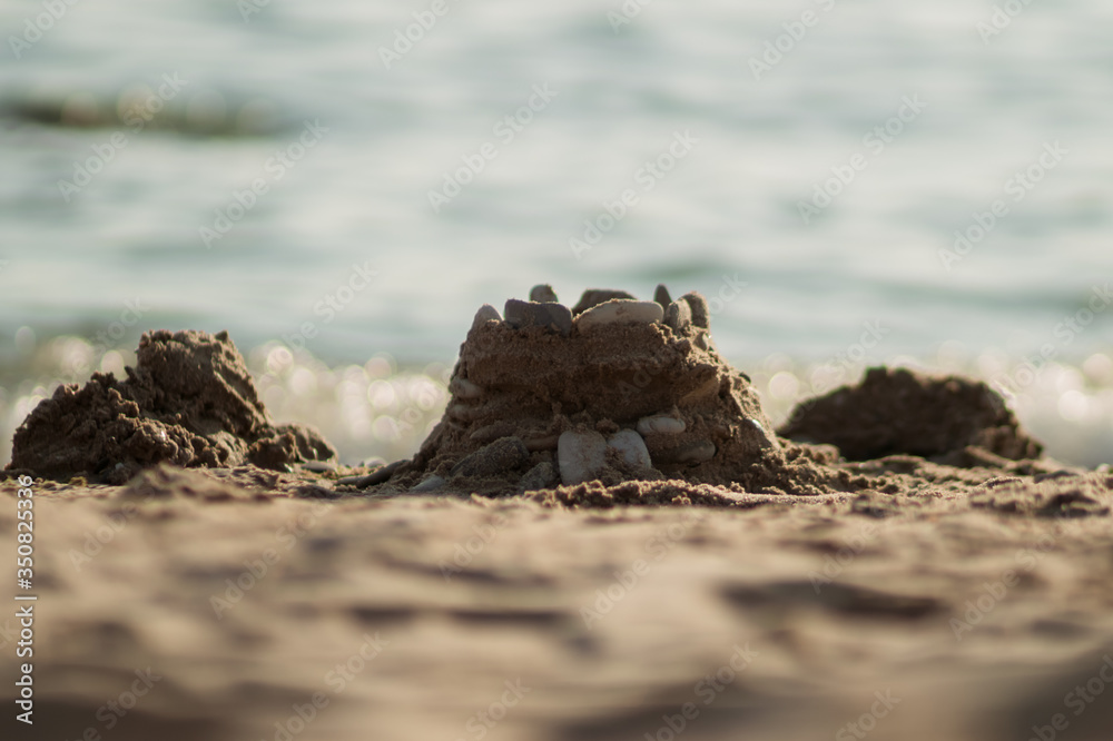 Sand castle on the beach with pebbles. Sand castle on the beach with pebbles.