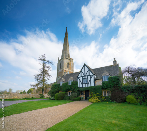 St Mary's Church and churchyard a blue sky day. Painswick is a town in the Cotswolds UK. photo