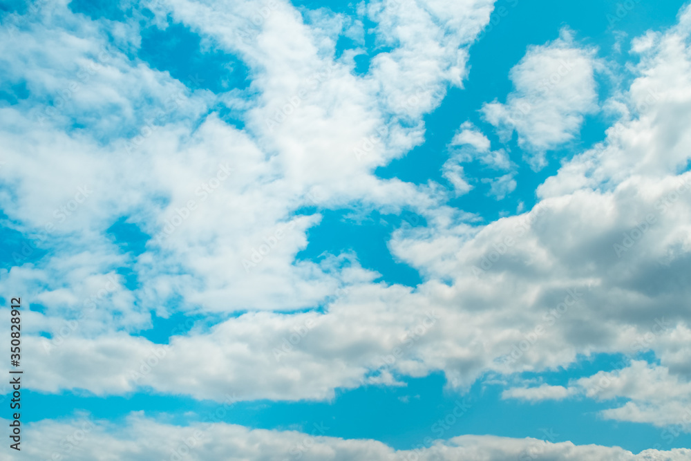Fototapeta premium Blue sky background with soft clouds. Weather forecast concept.