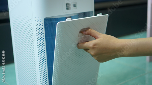 replaced a new filter into the air purifier machine. Preventing allergies. PM 2.5, Dirty air filter need to maintenance.