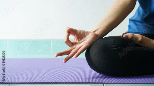 woman in meditating yoga instructor. sitting on lotus pose at home. Yoga concept.healthy lifestyle concept.