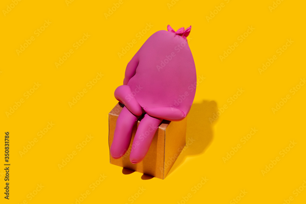 Life of rubber glove - protective wear isolated on yellow studio background with copyspace for ad. Must have during pandemic, epidemic, for protection and cleaning. Funny look from the inside.