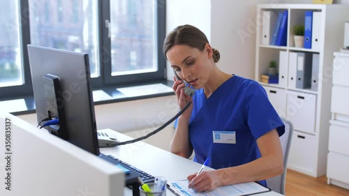 medicine, technology and healthcare concept - female doctor or nurse with computer calling on phone at hospital