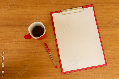 Office desk, note paper and accessories on the wooden table background, viewed from above