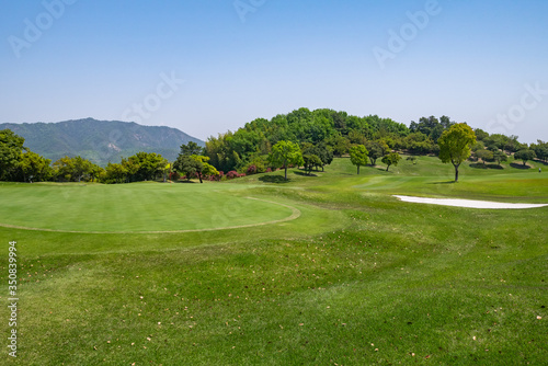 View of Golf Course with beautiful putting green. Golf course with a rich green turf beautiful scenery.