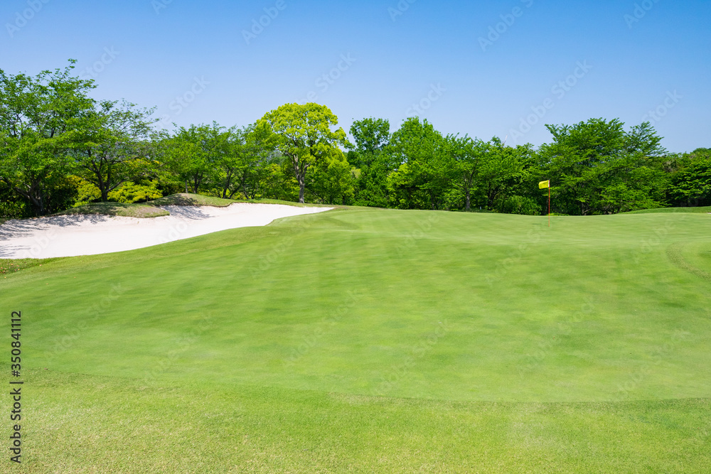 View of Golf Course with beautiful putting green. Golf course with a rich green turf beautiful scenery.