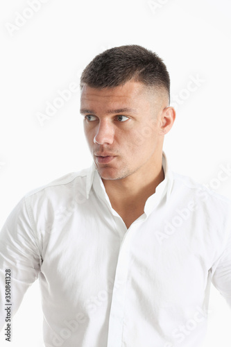 Young successful businessman on a white background in a shirt © H_Ko