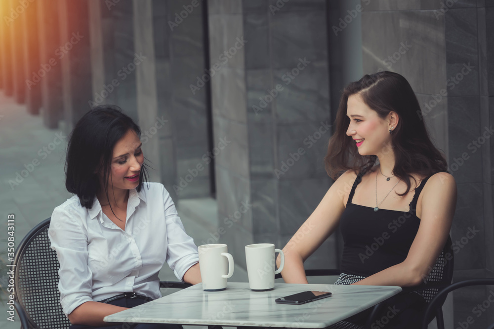 Beautiful women are enjoying coffee. coffee break with two women. Beautiful women are enjoying coffee. coffee break with two women.