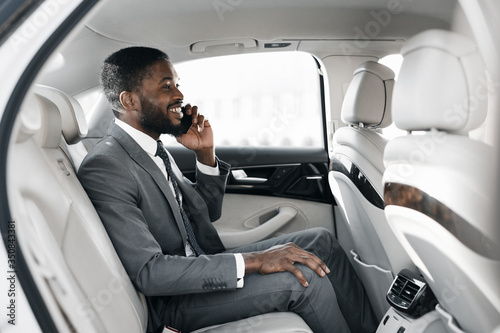 Entrepreneur Talking On Cellphone Sitting On Back Seat Of Car © Prostock-studio