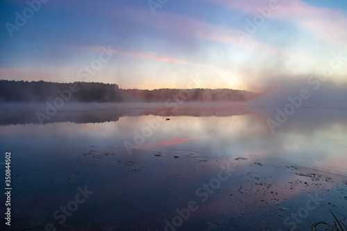 Mist over the lake dawn early morning in the summer