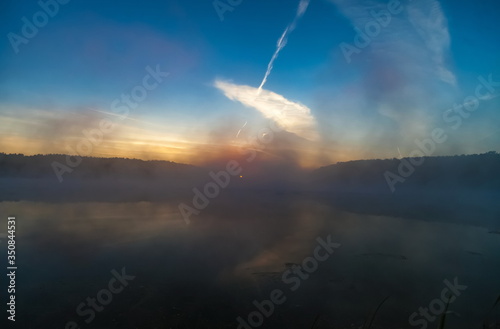 Mist over the lake dawn early morning in the summer