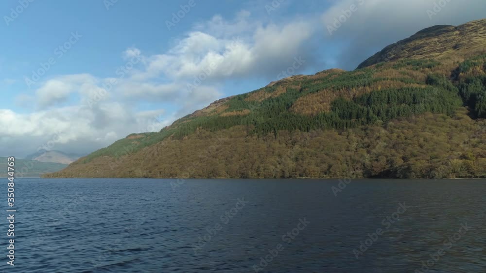 Panning movement shows Ben Lomand mountain face and surrounding Loch Lomand lake Panning movement shows Ben Lomand mountain face and surrounding Loch Lomand lake