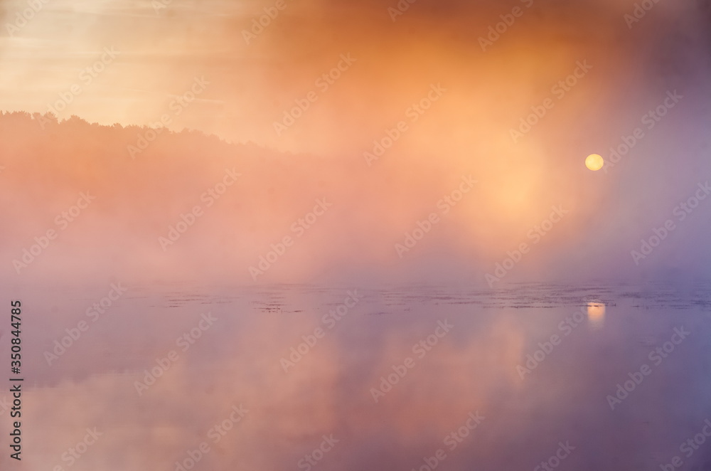 Mist over the lake dawn early morning in the summer