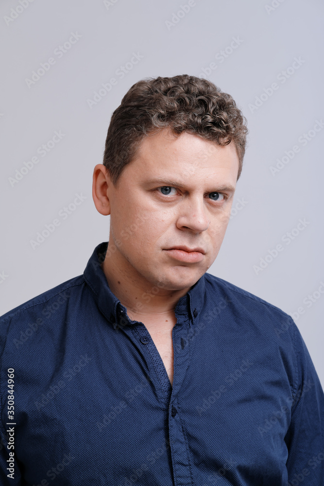 Studio portrait of man with hand on head Studio portrait of man with hand on head