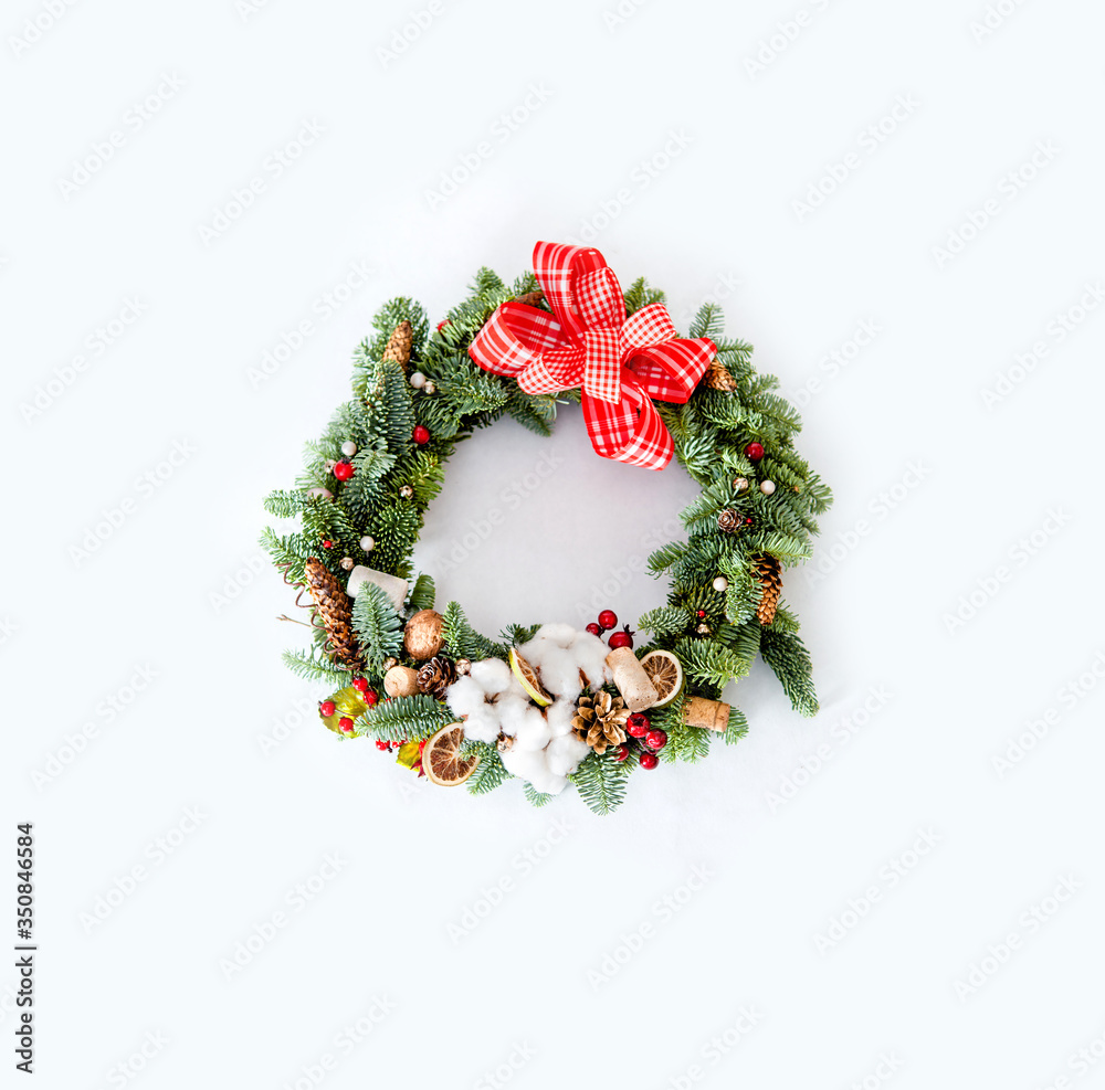 Christmas wreath with red shiny beads with flowers of cotton and slices of dried oranges Christmas wreath with red shiny beads with flowers of cotton and slices of dried oranges