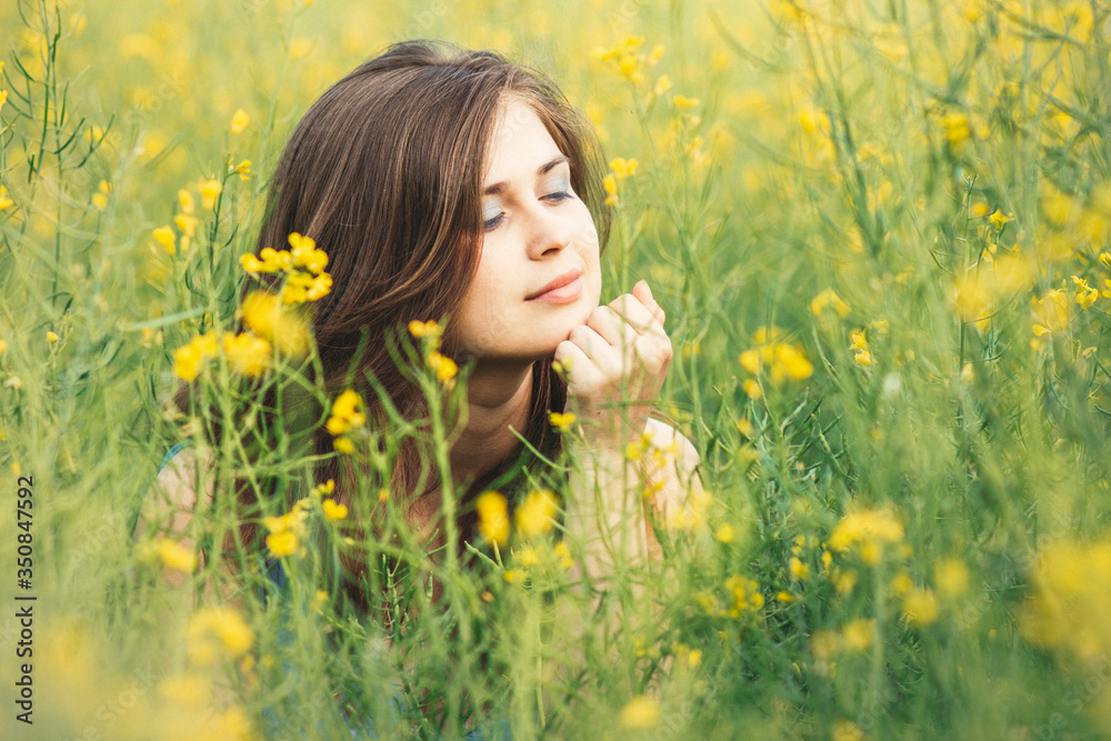 beautiful romantic girl on blooming rapeseed field enjoying nature, young elegant woman walking,pretty female face, concept happiness , freedom, inspiration beautiful romantic girl on blooming rapeseed field enjoying nature, young elegant woman walking,pretty female face, concept happiness , freedom, inspiration