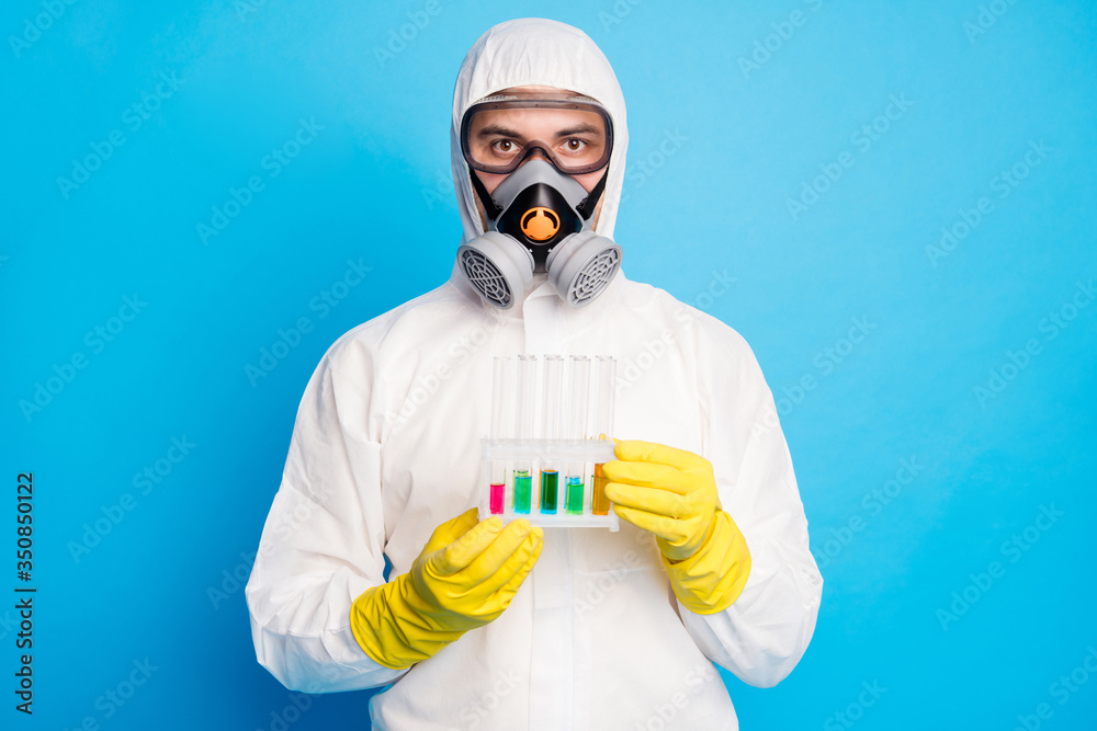 Portrait of smart scientist man hold test tube work future covid infection  vaccination wear white suit hazmat yellow latex gloves goggles isolated  over blue color background Stock-Foto | Adobe Stock