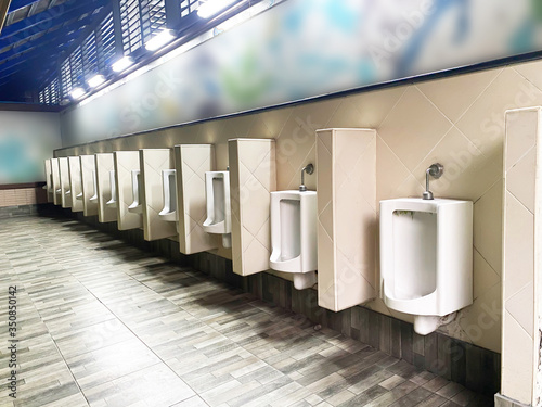 Men's white urinals design, Close up row of outdoor urinals men public toilet, Urinal concept. photo