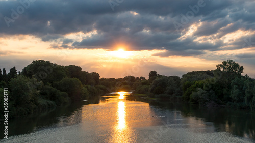Sunset over the river Ter