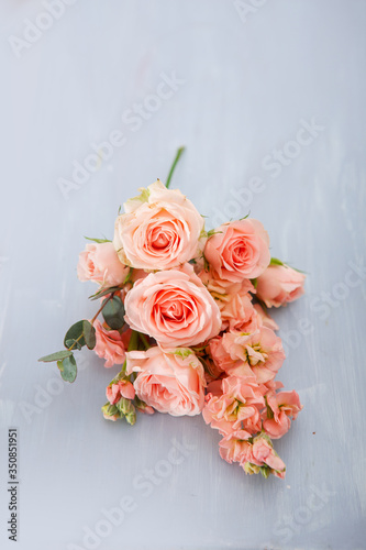 pink roses against the background of a vintage blue stool