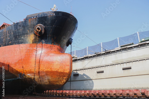 Bow in the dock, Ship in the dry dock close up, ship maintenance in shipyard.