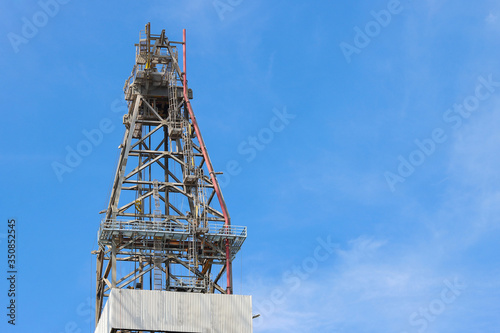 Low angle image oil rig drilling on blue sky with coppy space.