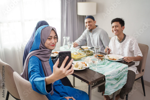 muslim family video calling and confrence with friend using mobile phone from home