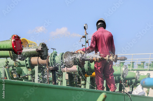 Station manifold pipe on oil tanker during hydrostatic, pressure testing and drain water after completed in shipyard. photo