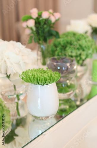 table decorated in green by using fresh flowers and candles