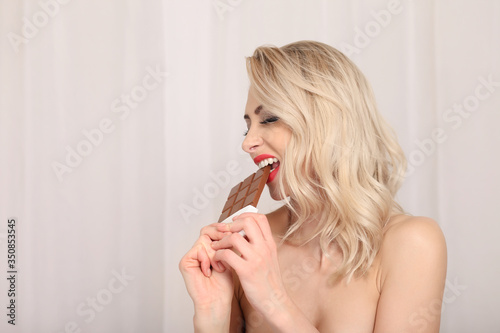 Attractive blonde eating chocolate