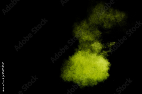 Light green powder explosion on black background. Colored powder cloud. Colorful dust explode. Paint Holi.