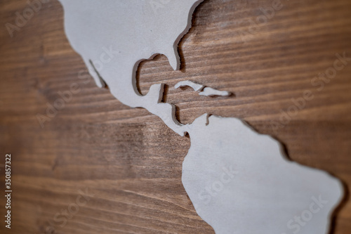 Handcrafted wooden world map with focus on Central America and the Caribbean